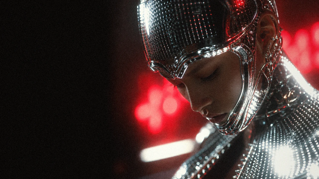 A close chrome identity portrait under red artificial light and shallow focus.
